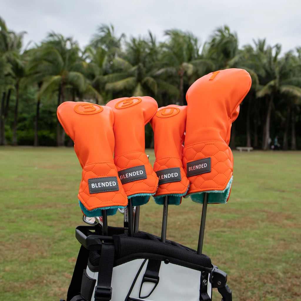 Bright orange driver head cover in a golf bag - fun pop of color stands out on any course