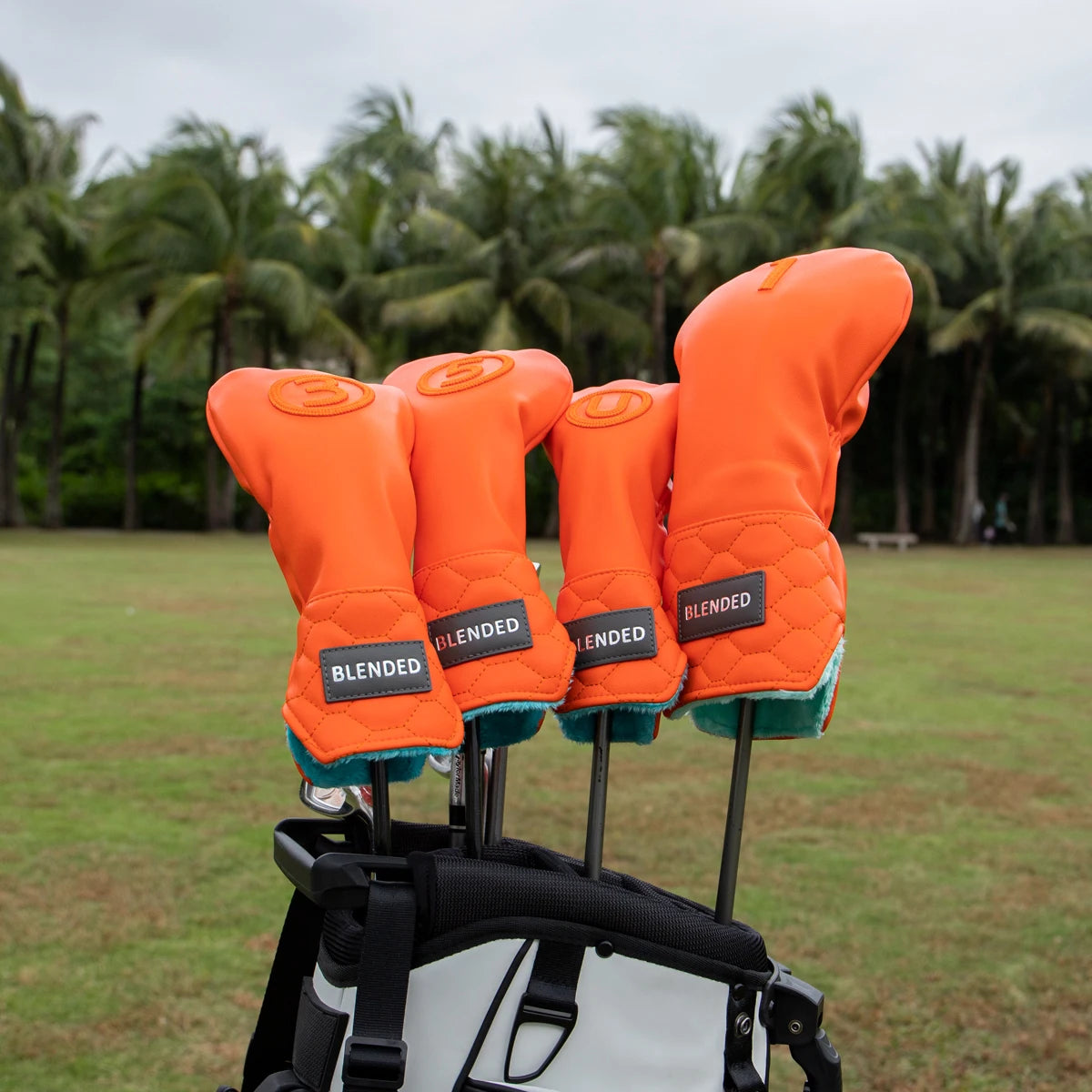 Bright orange driver head cover in a golf bag - fun pop of color stands out on any course