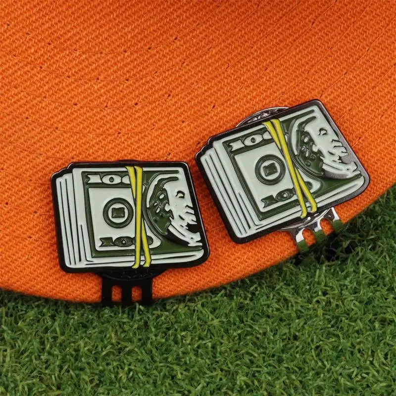 Close up of dollar bill design on stainless iron and black steel golf ball marker